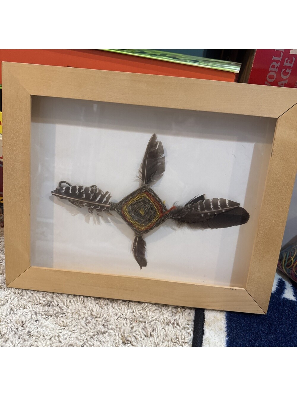 God's eye (Ojos de Dios) emblem with four natural feathers. 1951.